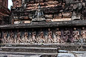 Thailand, Old Sukhothai - Wat Mahathat, stucco frieze runs around the base of the main chedi, it depicts a processions of monks with hands clasped in prayer.